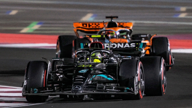 Mercedes' British driver Lewis Hamilton (foreground) drives ahead of McLaren's Australian driver Oscar Piastri during the qualifying session ahead of the Qatari Formula One Grand Prix at the Lusail International Circuit on October 6, 2023. (Photo by KARIM JAAFAR / AFP)
