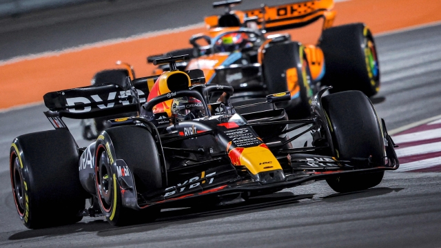 Red Bull Racing's Dutch driver Max Verstappen (foreground) and McLaren's Australian driver Oscar Piastri compete during the Qatari Formula One Grand Prix at Lusail International Circuit on October 8, 2023. (Photo by KARIM JAAFAR / AFP)