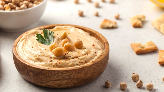 Banner hummus of their chickpeas in a wooden plate. Vegetarian food. High quality photo