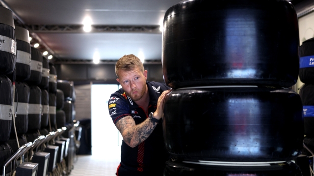 BARCELONA, SPAIN - JUNE 03: A Red Bull Racing team member pushes tyres in the Paddock prior to final practice ahead of the F1 Grand Prix of Spain at Circuit de Barcelona-Catalunya on June 03, 2023 in Barcelona, Spain. (Photo by Adam Pretty/Getty Images)
