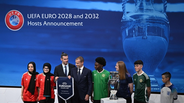 Welsh retired professional footballer, heading the delegation of Wales Gareth Bale (3rdL), flanked by UEFA president Aleksander Ceferin (4thL), poses with fans after United Kingdom and Ireland were elected to host the Euro 2028 fooball tournament during a ceremony at the UEFA headquarters  in Nyon on October 10, 2023. Seven years after awarding Euro-2024 to Germany, UEFA announced on October 10, 2023 the hosts for the next two editions: The United Kingdom and Ireland are due to host the tournament together in 2028, followed by the unprecedented tandem of Italy and Turkey in 2032. (Photo by Fabrice COFFRINI / AFP)