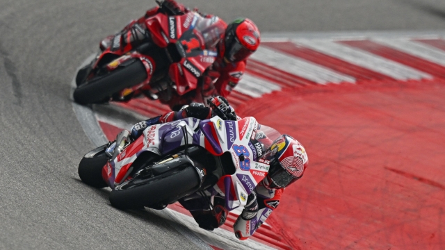 Prima Pramac Racing's Spanish rider Jorge Martin (R) and Ducati Lenovo Team's Italian rider Francesco Bagnaia steer their bikes during the Indian MotoGP Grand Prix at the Buddh International Circuit in Greater Noida on the outskirts of New Delhi, on September 24, 2023. (Photo by Money SHARMA / AFP)