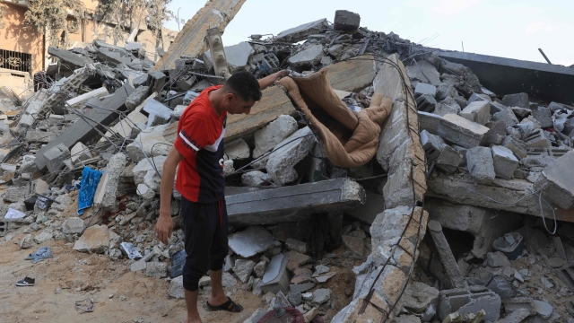 EDITORS NOTE: Graphic content / A Palestinian searches the rubble of a building following an Israeli strike, in the city Rafah, in the southern Gaza Strip on October 14, 2023, as battles between Israel and the Hamas movement continue for the eigth consecutive day,. Thousands of people, both Israeli and Palestinians have died since October 7, 2023, after Palestinian Hamas militants based in the Gaza Strip, entered southern Israel in a surprise attack leading Israel to declare war on Hamas in Gaza on October 8. (Photo by SAID KHATIB / AFP)