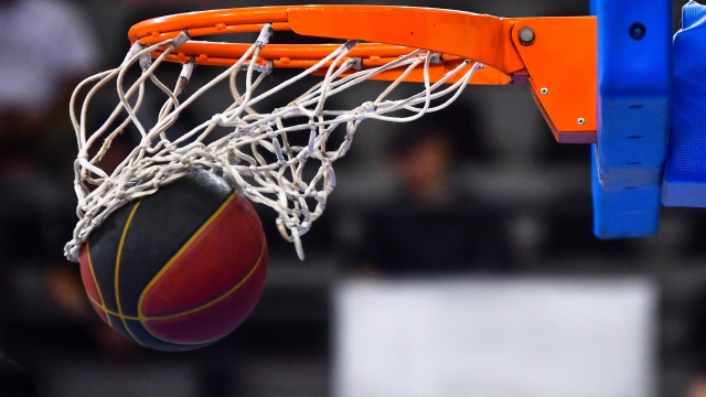 Ball falling through a Basketball Hoop