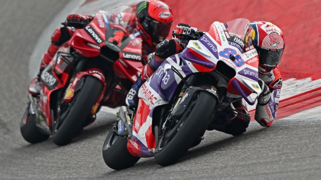 TOPSHOT - Prima Pramac Racing's Spanish rider Jorge Martin (R) and Ducati Lenovo Team's Italian rider Francesco Bagnaia steer their bikes during the Indian MotoGP Grand Prix at the Buddh International Circuit in Greater Noida on the outskirts of New Delhi, on September 24, 2023. (Photo by Money SHARMA / AFP)