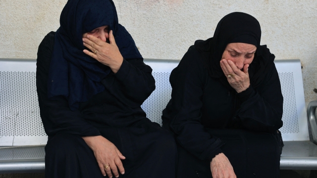 Palestinian women react as they wait to collect the body of relatives from the hospital, following Israeli military attacks on Rafah, in the southern of Gaza Strip on October 16, 2023. The death toll from Israeli strikes on the Gaza Strip has risen to around 2,750 since Hamas's deadly attack on southern Israel last week, the Gaza health ministry said October 16. Some 9,700 people have also been injured as Israel continued its withering air campaign on targets in the Palestinian coastal enclave, the Hamas-controlled ministry added. (Photo by SAID KHATIB / AFP)