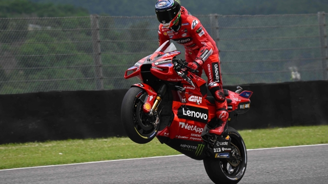 TOPSHOT - Ducati Italian rider Francesco Bagnaia celebrates after taking the pole position after the qualifying rounds ahead of the Italian MotoGP race at Mugello Circuit in Mugello, on June 10, 2023. (Photo by Filippo MONTEFORTE / AFP)