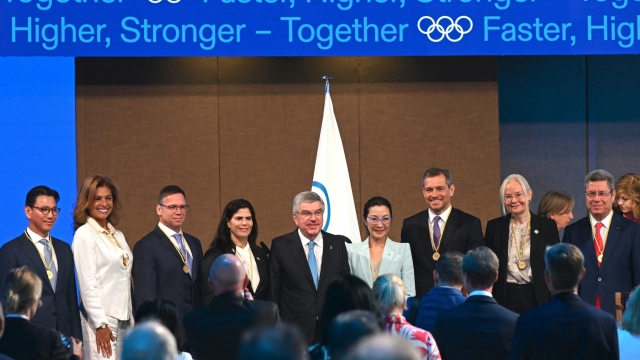 Newly elected International Olympic Committee (IOC) members (from L) South Korea's Kim Jae-youl, president of the International Skating Union, Cecilia Tait, former Olympic medallist and politician from Peru, Hungarian businessman and sports administrator Balazs Furjes, Israel's first Olympic medallist Yael Arad, IOC President Thomas Bach, Malaysian actress Michelle Yeoh, German sports entrepreneur Michael Mronz, Sweden's Petra Soerling, head of the International Table Tennis Federation, and Mehrez Boussayene, president of the Tunisian Olympic Committee, pose for a group picture during the third day of the 141st IOC session in Mumbai on October 17, 2023. (Photo by INDRANIL MUKHERJEE / AFP)
