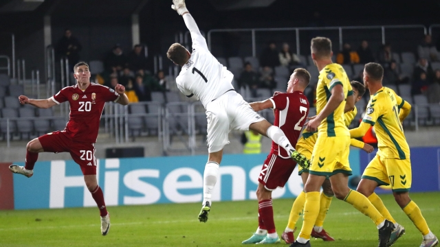 epa10924337 Goalkeeper Emilijus Zubas of Lithuania in action against Roland Sallai (L) of Hungary during the UEFA EURO 2024 group G qualification round match between Lithuania and Hungary in Kaunas, Lithuania, 17 October 2023.  EPA/TOMS KALNINS