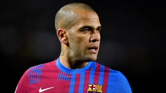 (FILES) In this file photo taken on February 27, 2022 Barcelona's Brazilian defender Dani Alves looks on during the Spanish league football match between FC Barcelona and Athletic Club Bilbao at the Camp Nou stadium in Barcelona. - Brazil defender Dani Alves was back in court on April 17, 2023 to testify before the judge investigating a rape allegation made by a woman in Barcelona for which he has been held in pre-trial detention. The 39-year-old, who has been remanded in custody since January 20, appeared in court at his own request, giving a 30-minute statement to the judge in which he reiterated his claim that the sex was consensual, judicial sources said. (Photo by Pau BARRENA / AFP)
