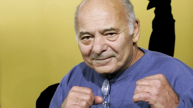 FILE - Burt Young, a cast member of the film "Rocky Balboa," gestures at the premiere of the film in Los Angeles, Dec. 13, 2006.  Burt Young, the Oscar-nominated actor who played Paulie, the rough-hewn, mumbling-and-grumbling best friend, corner-man and brother-in-law to Sylvester Stallone in the ?Rocky? franchise, has died. Young died Oct. 8, 2023 in Los Angeles. (AP Photo/Kevork Djansezian, File)