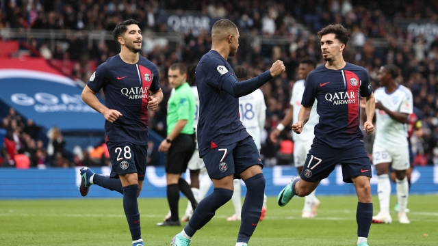 Paris Saint-Germain's French forward #07 Kylian Mbappe (C) celebrates with Paris Saint-Germain's Spanish midfielder #28 Carlos Soler (L) and Paris Saint-Germain's Portuguese midfielder #17 Vitinha (R) scoring his team's first goal during the French L1 football match between Paris Saint-Germain (PSG) and Strasbourg at the Parc des Princes stadium in Paris on October 21, 2023. (Photo by FRANCK FIFE / AFP)