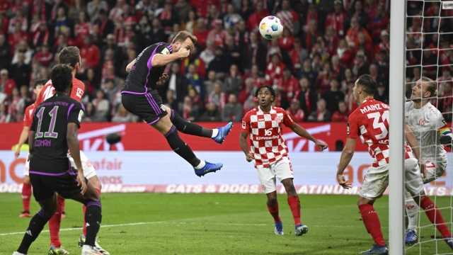 Munich's Harry Kane, centre, scores a goal, during the Bundesliga soccer match between Mainz 05 and Bayern Munich at Mewa Arena in Mainz, Germany, Saturday, Oct. 21, 2023. (Arne Dedert/dpa via AP)