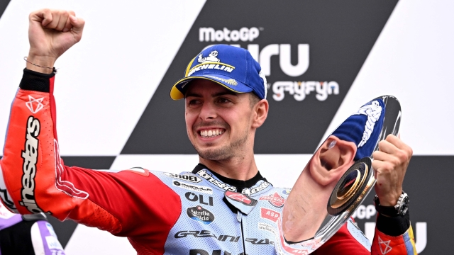 Third placed Gresini Racing's Italian rider Fabio Di Giannantonio celebrates on the podium after the MotoGP Australian Grand Prix at Phillip Island on October 21, 2023. (Photo by WILLIAM WEST / AFP) / -- IMAGE RESTRICTED TO EDITORIAL USE - STRICTLY NO COMMERCIAL USE --