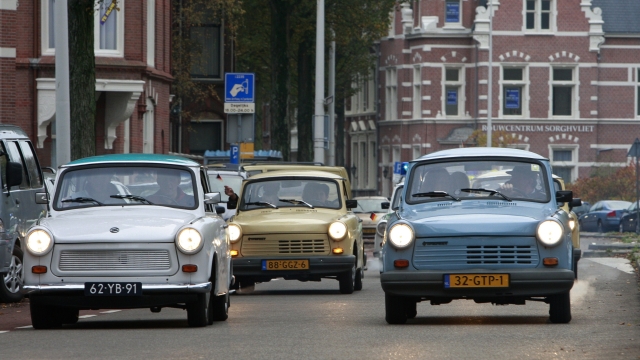 Trabants are driven near the German embassy in The Hague on November 9, 2009. Germany is celebrating the 20th anniversary of the fall of the Berlin Wall on November 9, 2009 with many world leaders coming to Berlin to mark the event.  AFP PHOTO / Anoek DE GROOT
