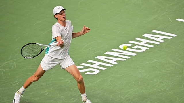 Italy's Jannik Sinner hits a return to US's Ben Shelton in their men's singles match during the Shanghai Masters tennis tournament in Shanghai on October 10, 2023. (Photo by Hector RETAMAL / AFP)