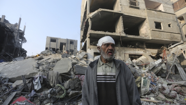 A Palestinian stands outside the building destroyed i the Israeli bombardment of the Gaza Strip in Rafah, Wednesday, Oct 25, 2023. (AP Photo/Hatem Ali)