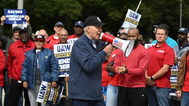 (FILES) US President Joe Biden addresses striking members of the United Auto Workers (UAW) union at a picket line outside a General Motors Service Parts Operations plant in Belleville, Michigan, on September 26, 2023. An auto workers strike in the United States expanded October 11, 2023 with 8,700 more employees walking off their jobs, said the United Automobile Workers (UAW) union, as a deal with major automakers remained elusive. (Photo by Jim WATSON / AFP)