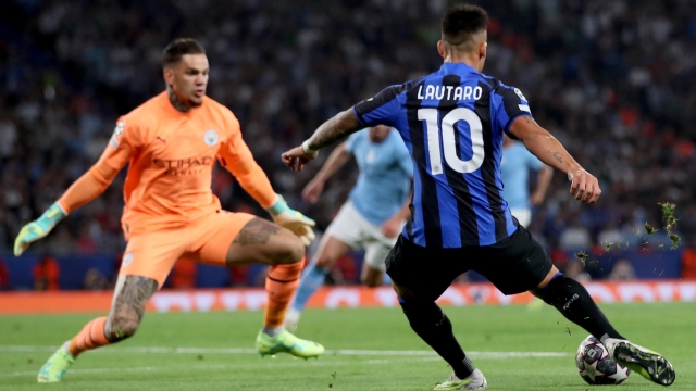 epa10684249 Manchester City goalkeeper Ederson and Lautaro Martinez of Inter in action during the UEFA Champions League Final soccer match between Manchester City and Inter Milan, in Istanbul, Turkey, 10 June 2023.  EPA/TOLGA BOZOGLU