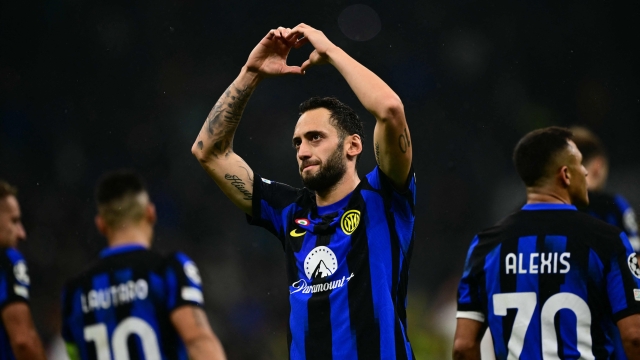 TOPSHOT - Inter Milan's Turkish midfielder #20 Hakan Calhanoglu celebrates after scoring a penalty during the UEFA Champions League 1st round day 3 Group D football match between Inter Milan and Salzburg at the San Siro stadium in Milan on October 24, 2023. (Photo by Marco BERTORELLO / AFP)