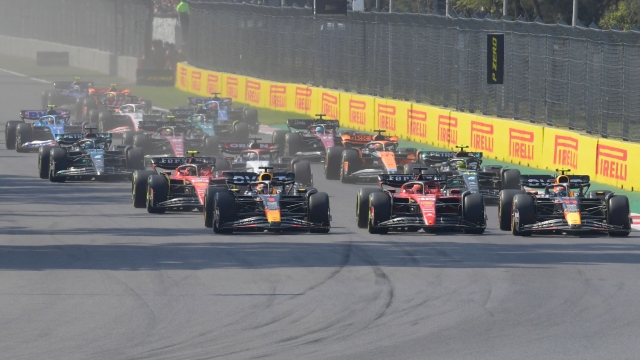 (L to R) Red Bull Racing's Dutch driver Max Verstappen, Ferrari's Monegasque driver Charles Leclerc and Red Bull Racing's Mexican driver Sergio Perez take the lead at the start of the Formula One Mexico Grand Prix at the Hermanos Rodriguez racetrack in Mexico City on October 29, 2023. (Photo by CLAUDIO CRUZ / AFP)