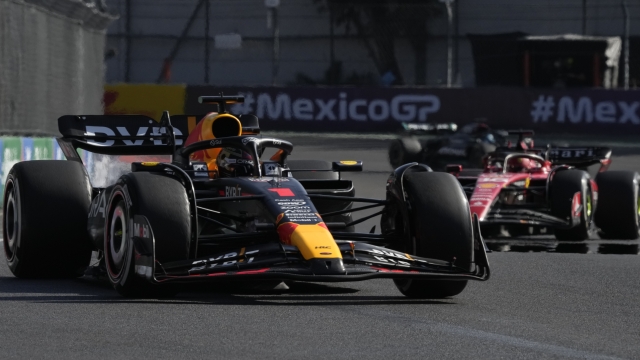 Max Verstappen, of Netherlands, steers his Red Bull followed by Ferrari driver Charles Leclerc of Monaco during the Formula One Mexico Grand Prix auto race at the Hermanos Rodriguez racetrack in Mexico City, Sunday, Oct. 29, 2023.. (AP Photo/Fernando Llano)