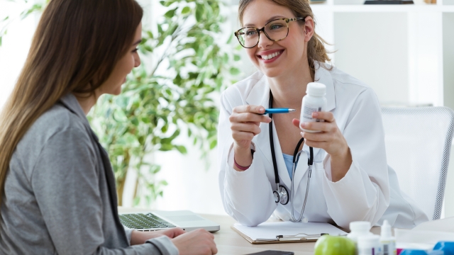 Shot of female dietician prescribing nutritional supplement for patient in the consultation.