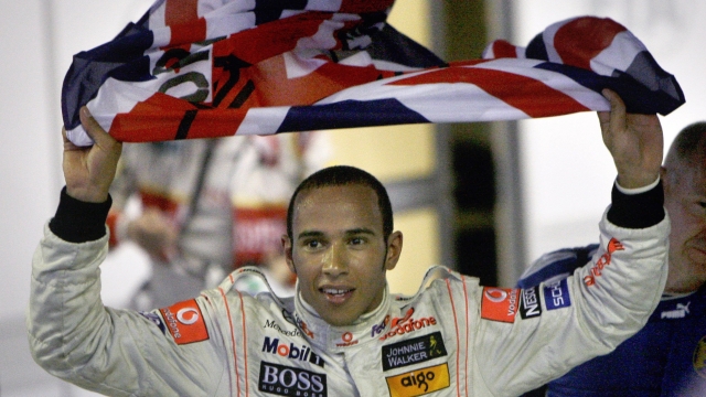 McLaren-Mercedes' Formula One driver Lewis Hamilton, of Britain, celebrates after he secured the 2008 Formula One world drivers' championship by finishing fifth in the Brazilian Formula One Grand Prix at the Interlagos race track in Sao Paulo, Sunday, Nov. 2, 2008.  (AP Photo/Silvia Izquierdo)