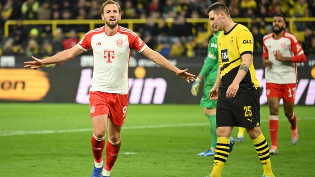 Bayern Munich's English forward #09 Harry Kane (L) celebrates scoring the 0-4 goal  next to Dortmund's German defender #25 Niklas Suele during the German first division Bundesliga football match between BVB Borussia Dortmund and FC Bayern Munich in Dortmund, western Germany on November 4, 2023. (Photo by INA FASSBENDER / AFP) / DFL REGULATIONS PROHIBIT ANY USE OF PHOTOGRAPHS AS IMAGE SEQUENCES AND/OR QUASI-VIDEO