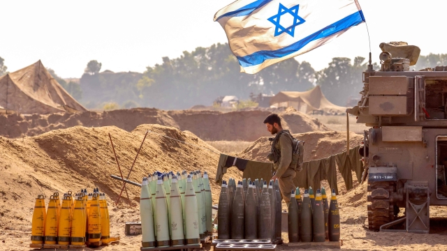TOPSHOT - An Israeli soldier arranges artillery shells at a position near the border with the Gaza Strip in southern Israel on November 6, 2023 amid the ongoing battles between Israel and the Palestinian group Hamas in the Gaza Strip. (Photo by JACK GUEZ / AFP)