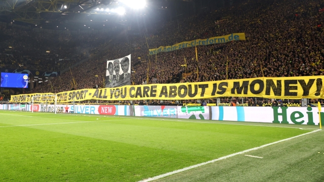 epa10963069 Dortmund fans hold a transparent to protest against the planned UEFA Champions League reform during the UEFA Champions League group F soccer match between Borussia Dortmund and Newcastle United in Dortmund, Germany, 07 November 2023.  EPA/CHRISTOPHER NEUNDORF