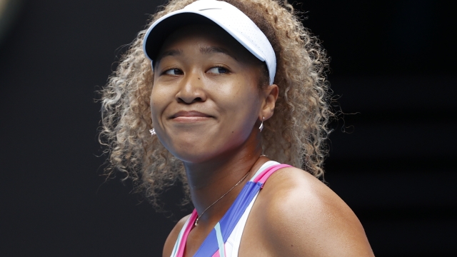 FILE - Naomi Osaka of Japan smiles during her first round match against Camila Osorio of Colombia at the Australian Open tennis championships, Jan. 17, 2022, in Melbourne, Australia. The four-time Grand Slam singles champion Osaka will make her comeback to tennis at the Brisbane International warm-up tournament ahead of the Australian Open. Tournament officials confirmed Friday, Nov. 10, 2023, that Osaka will contest the Dec. 31-Jan. 7, 2024, event to start her 2024 season. (AP Photo/Simon Baker, File)