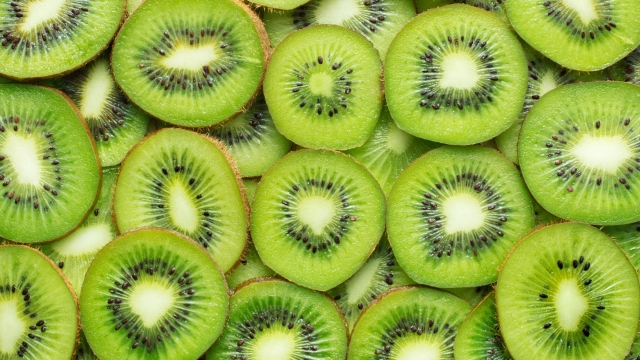 heap of sliced ripe kiwi as textured background