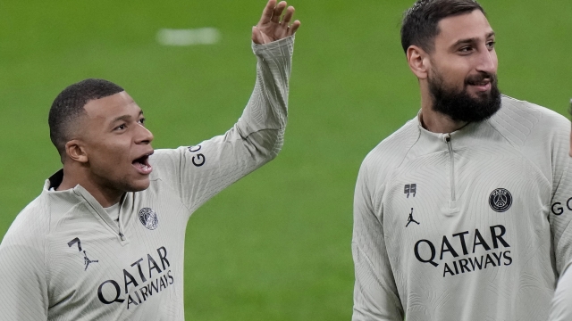 PSG's Kylian Mbappe gestures flanked by goalkeeper Gianluigi Donnarumma during a training session ahead the tomorrow's Champions League, Group F soccer match between AC Milan and PSG, at the San Siro stadium in Milan, Italy, Monday, Nov. 6, 2023. (AP Photo/Luca Bruno)