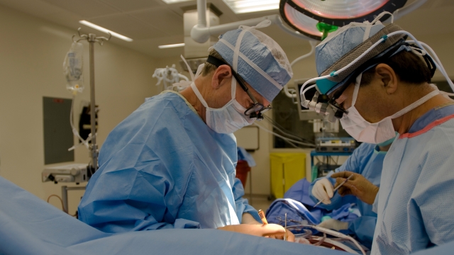 open heart cardiac bypass surgery in full operation room,