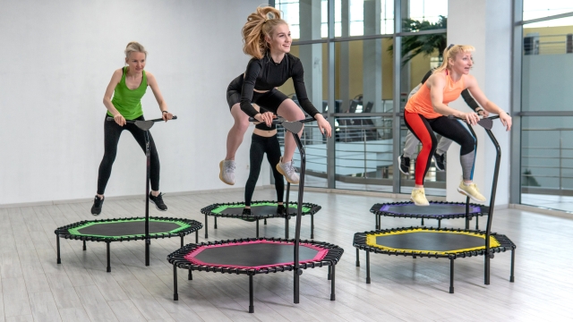 Trampoline for fitness girls are engaged in professional sports, the concept of a healthy lifestyle jumping trampoline woman fitness jump girl, for exercise health for female from energy wellness, club vitality. Instructor cute bounce, dance