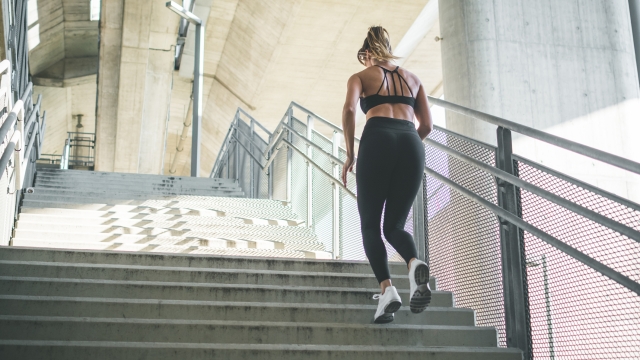 Young fit woman running on stairs