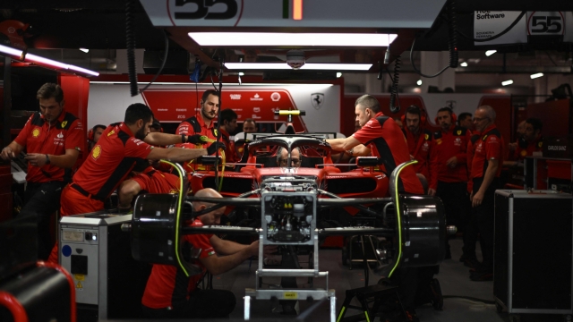Mechanics work on the car of Ferrari's Spanish driver Carlos Sainz Jr. ahead of the second practice session for the Las Vegas Grand Prix on November 17, 2023, in Las Vegas, Nevada. (Photo by Jim WATSON / AFP)