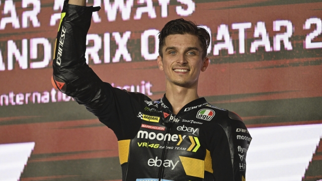 DOHA, QATAR - NOVEMBER 19:  Luca Marini of Italy and Mooney VR46 Racing Team celebrates the third place on the podium during the MotoGP race during the MotoGP of Qatar - Race at Losail Circuit on November 19, 2023 in Doha, Qatar. (Photo by Mirco Lazzari gp/Getty Images)