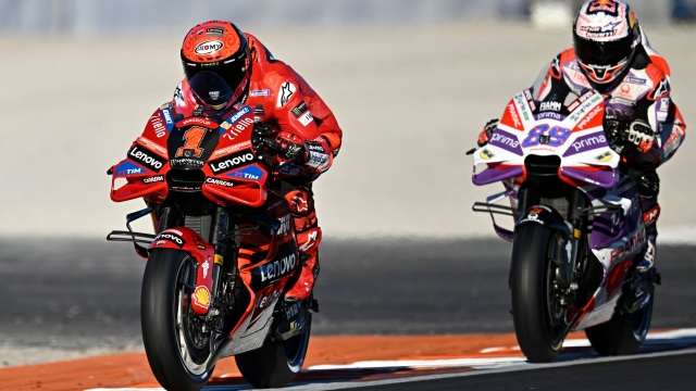 Ducati Spanish rider Jorge Martin (R) and Ducati Italian rider Francesco Bagnaia take part in the second free practice session of the MotoGP Valencia Grand Prix at the Ricardo Tormo racetrack in Cheste, on November 24, 2023. (Photo by JAVIER SORIANO / AFP)