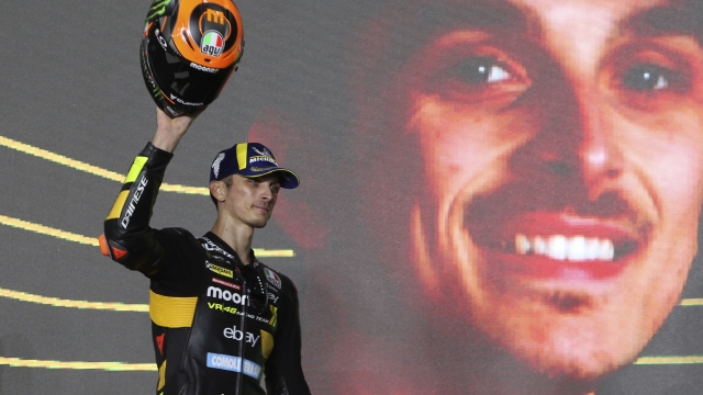 Third placed, Ducati rider Luca Marini, of Italy, celebrate on the podium end of the Qatari MotoGP Grand Prix at the Lusail International Circuit in Lusail, Qatar, Sunday, Nov. 19, 2023. (AP Photo/Hussein Sayed)   Associated Press/LaPresse Only Italy and Spain