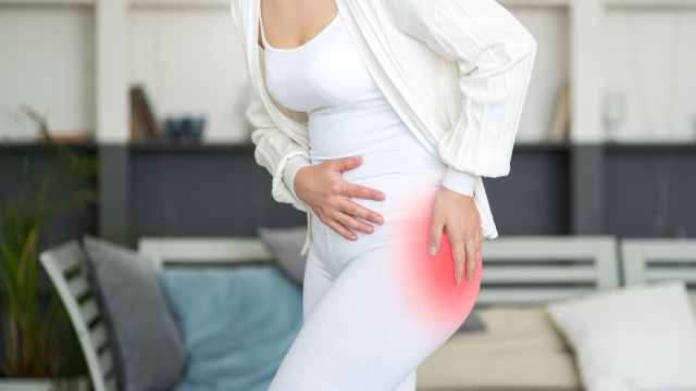 Hip pain, woman suffering from osteoarthritis at home, health problems concept