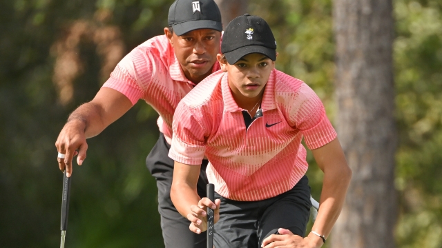 ORLANDO, FLORIDA - DECEMBER 17: Tiger Woods and his son, Charlie Woods, read the putt together on the first green during the first round of the PGA TOUR Champions PNC Championship at The Ritz-Carlton Golf Club on December 17, 2022 in Orlando, Florida. (Photo by Ben Jared/PGA TOUR via Getty Images)