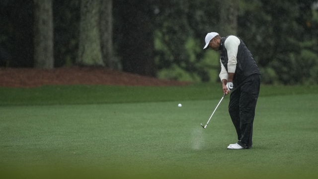 Tiger Woods hits from the fairway on the 18th hole during the weather delayed second round of the Masters golf tournament at Augusta National Golf Club on Saturday, April 8, 2023, in Augusta, Ga. (AP Photo/Matt Slocum)