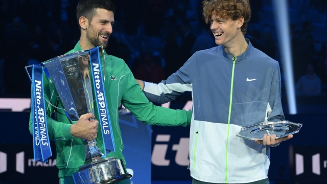 Novak Djokovic (L) of Serbia celebrates with the trophy after winning the final against Jannik Sinner (R) of Italy at the Nitto ATP Finals tennis tournament in Turin, Italy, 19 November 2023.  ANSA/ALESSANDRO DI MARCO