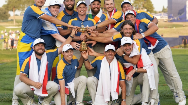 FILE - Europe's Team Captain Luke Donald, centre, and team members lift the Ryder Cup after winning the trophy by defeating the United States 16/12 point to 11 1/2 points at the Marco Simone Golf Club in Guidonia Montecelio, Italy, on Oct. 1, 2023. Luke Donald is staying on as captain of the European team for its defense of the Ryder Cup in 2025 at Bethpage Black. The 45-year-old Donald led the Europeans to a 16½-11½ victory over the United States outside Rome last month and the European tour said Wednesday Nov. 29, 2023 he is being retained as captain. (AP Photo/Alessandra Tarantino, File)