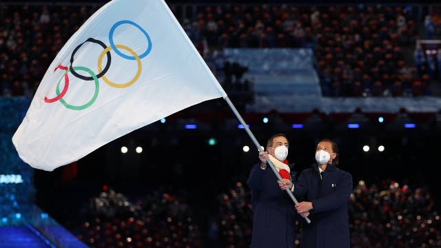 BEIJING, CHINA - FEBRUARY 20: Guiseppe Sala, Mayor of Milano city and Gianpetro Ghedina, Mayor of Cortina d' Ampezzo City wave the Olympic flag during the Beijing 2022 Winter Olympics Closing Ceremony on Day 16 of the Beijing 2022 Winter Olympics at Beijing National Stadium on February 20, 2022 in Beijing, China. (Photo by Maja Hitij/Getty Images)