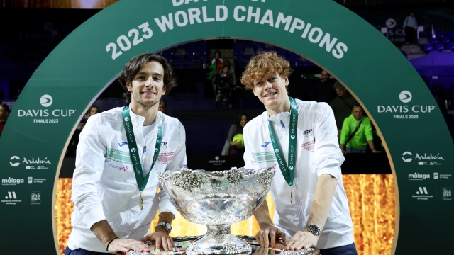 MALAGA, SPAIN - NOVEMBER 26: Lorenzo Musetti and Jannik Sinner of Italy celebrate with the Davis Cup Trophy after their teams victory during the Davis Cup Final match against Australia at Palacio de Deportes Jose Maria Martin Carpena on November 26, 2023 in Malaga, Spain. (Photo by Clive Brunskill/Getty Images for ITF)