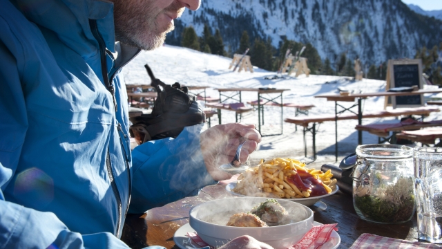 Man eating lunch at a mountain hut