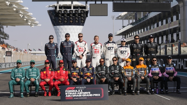F1 drivers pose for a group picture ahead the drivers parade prior to the Abu Dhabi Formula One Grand Prix at the Yas Marina racetrack in Abu Dhabi, United Arab Emirates, Sunday, Nov. 26, 2023. (AP Photo/Kamran Jebreili)